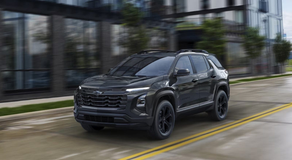 Black 2026 Chevy Equinox driving on a city street