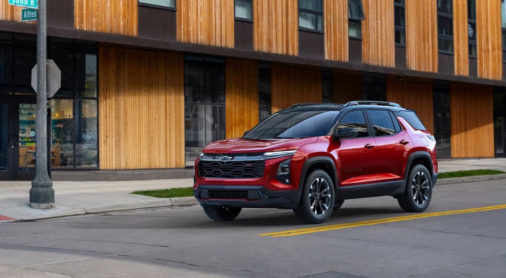 Red 2026 Chevy Equinox driving on a city street
