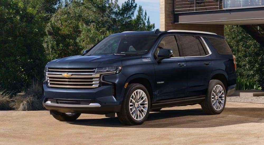 Blue 2023 Chevy Tahoe is shown parked in a driveway.