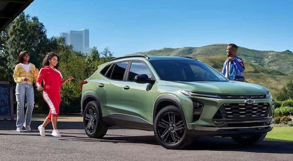 Green 2024 Chevy Trax, is shown parked near several people.