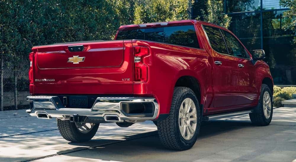 A red 2025 Chevy Silverado 1500 parked in a driveway