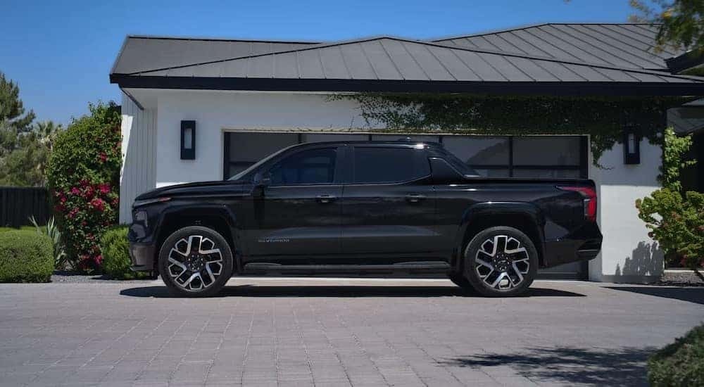 A black 2025 Chevy Silverado EV RST parked on a driveway.