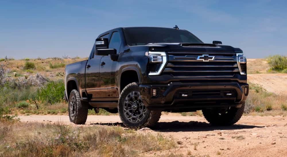 Black 2026 Chevy Silverado 2500 HD for sale parked off-road