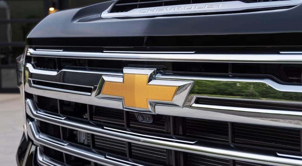 The front badge of a black 2024 Chevy Silverado 2500 HD High Country is shown.