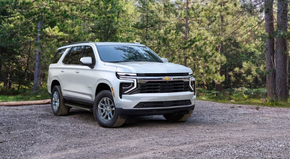 White 2025 Chevy Tahoe LS for sale parked near a forest