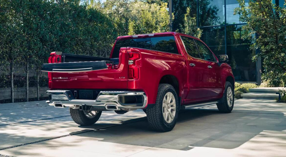 The multi-flex tailgate of a red 2026 Chevy Silverado 1500