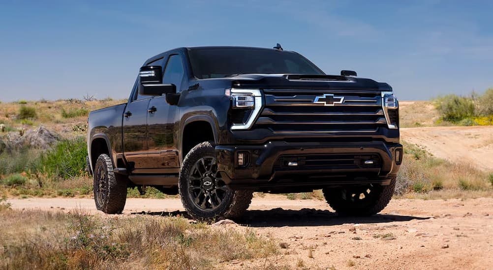 A black 2026 Chevy Silverado 2500 parked off-road.