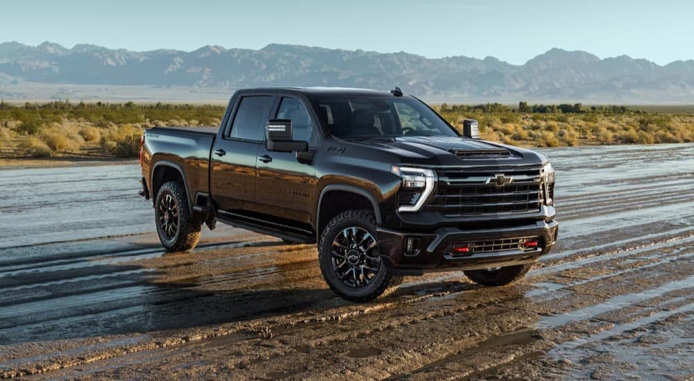 A black 2026 Chevy Silverado 2500 parked off-road.