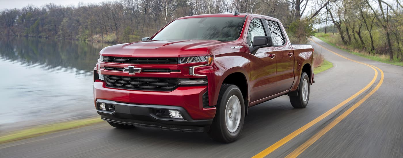 Red 2019 Chevy Silverado 1500 RST driving past a lake