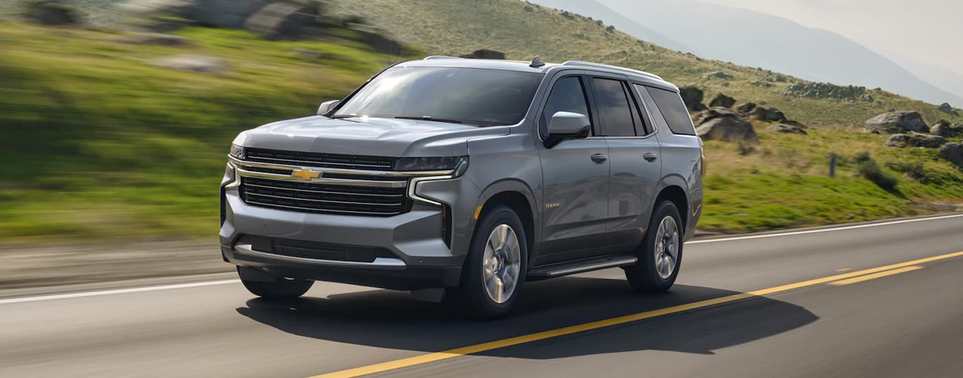 Silver 2021 Chevy Tahoe driving along an open road