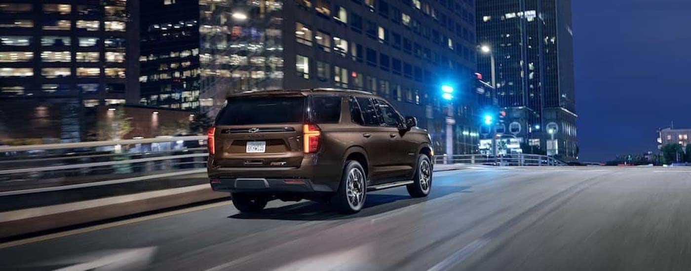A brown 2022 Chevy Tahoe is shown from the rear at an angle.