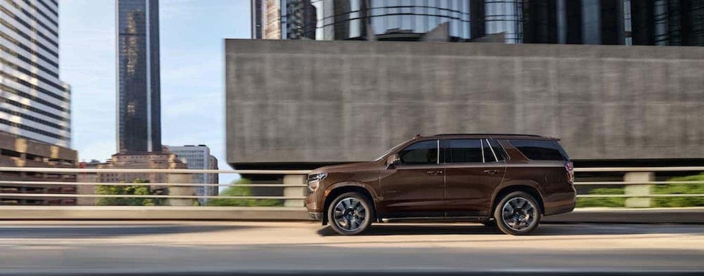 A brown 2022 Chevy Tahoe RST is shown from the side on the freeway.