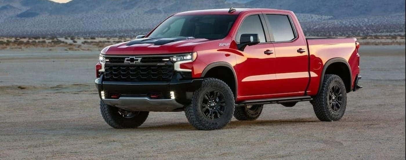 A red 2022 Chevy Silverado 1500 ZR2 is shown parked off-road