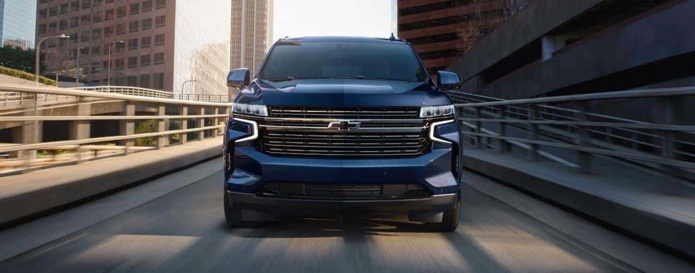 Blue 2023 Chevy Tahoe head on driving down the road