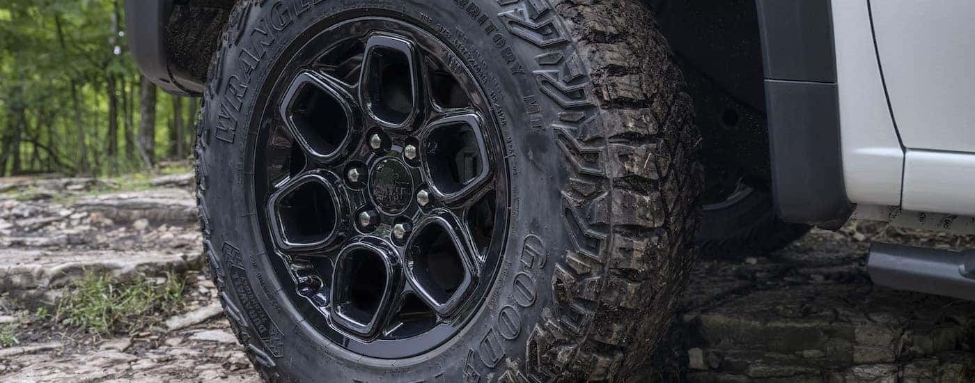 A close up shows the black wheel on a white 2023 Chevy Silverado ZR2 Bison.