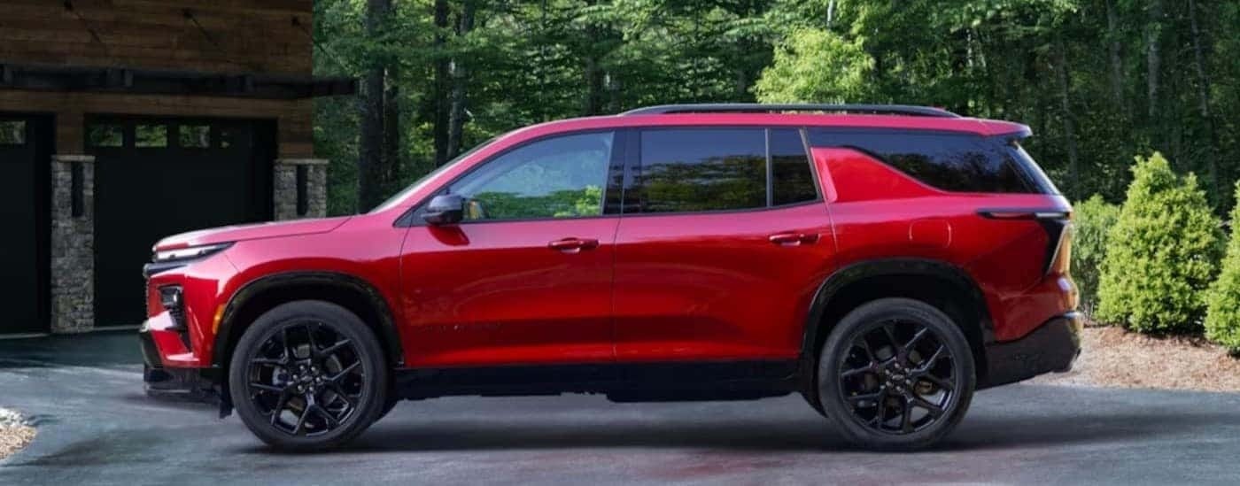 A red 2024 Chevy Traverse is shown parked to look at SUVs for sale