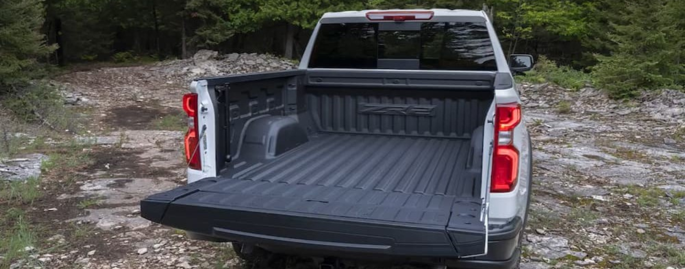 The tailgate open on a silver 2026 Chevy Silverado 1500
