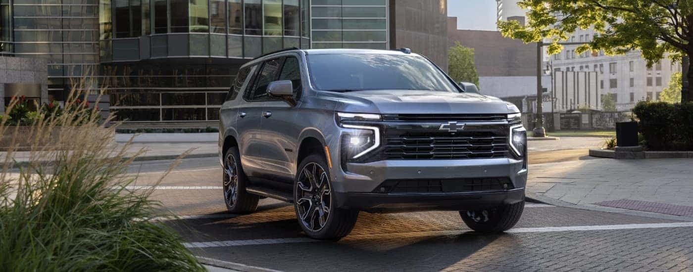 A silver 2025 Chevy Tahoe RST is shown from the front at an angle.