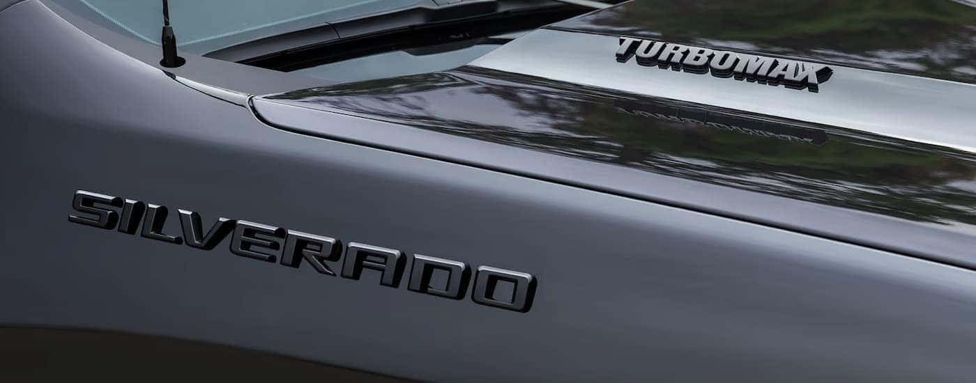 Hood and badge on a black 2026 Chevy Silverado 1500