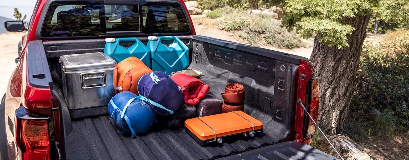 Bed of a red 2026 Chevy Colorado filled with equitment