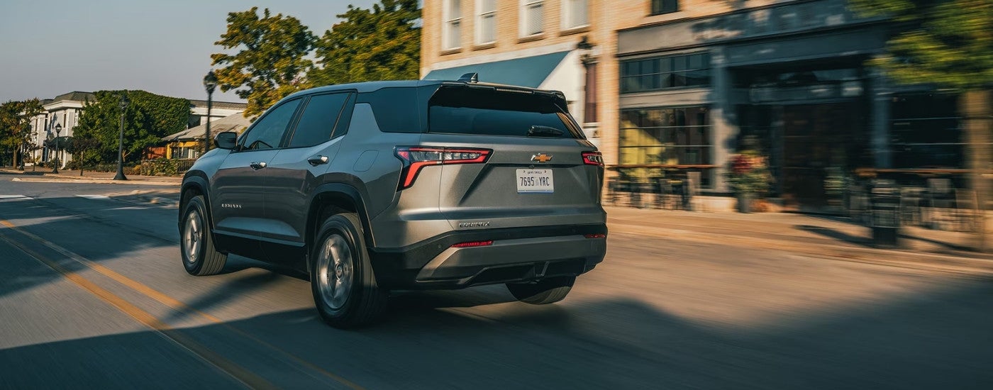 Grey 2026 Chevy Equinox driving on a city street