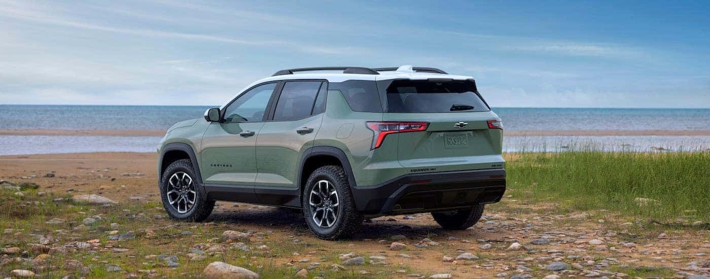 A green 2025 Chevy Equinox ACTIV from the rear.