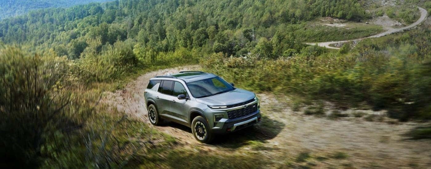 Silver 2024 Chevy Traverse Z71 for sale driving off-road.