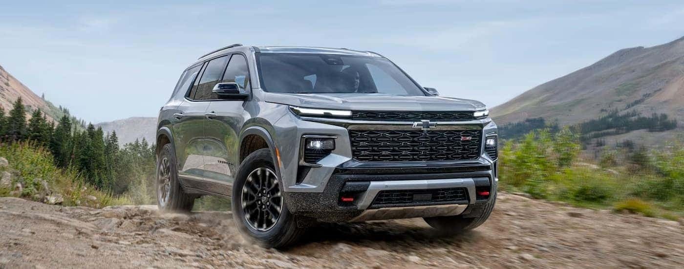 Silver 2025 Chevy Traverse driving off-road.