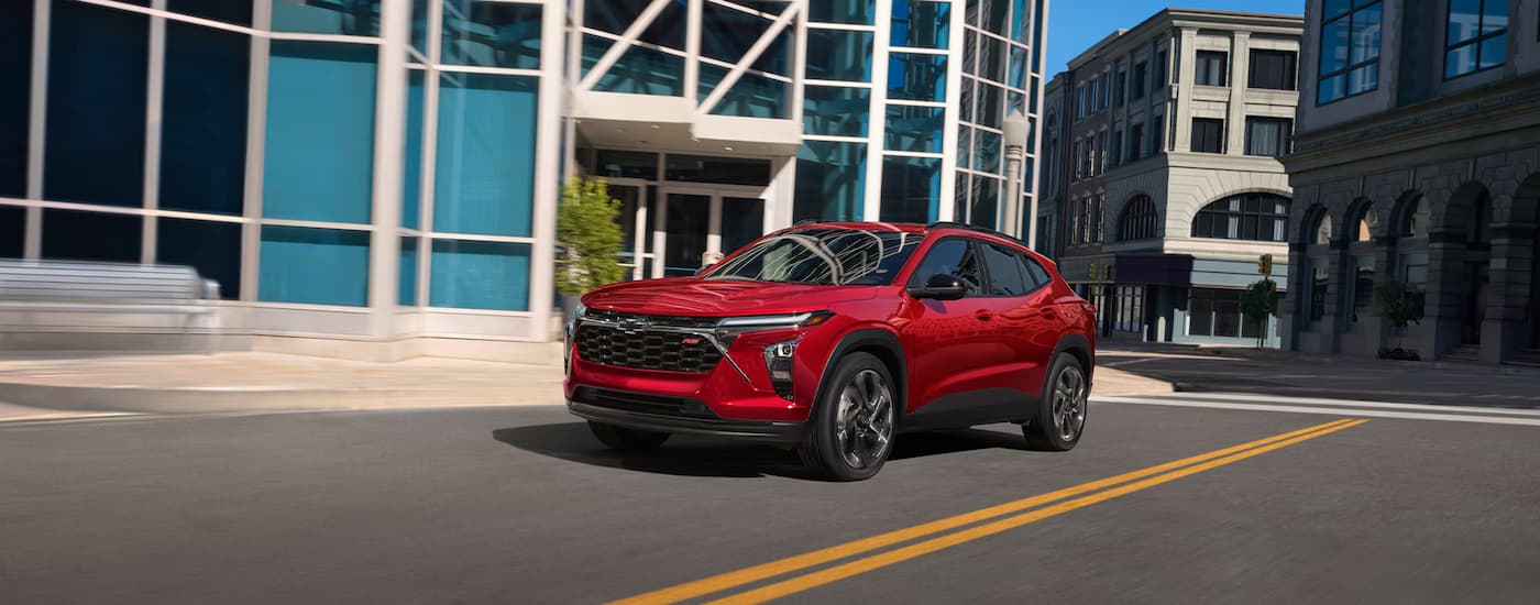 Red 2026 Chevy Trax RS driving on a city street