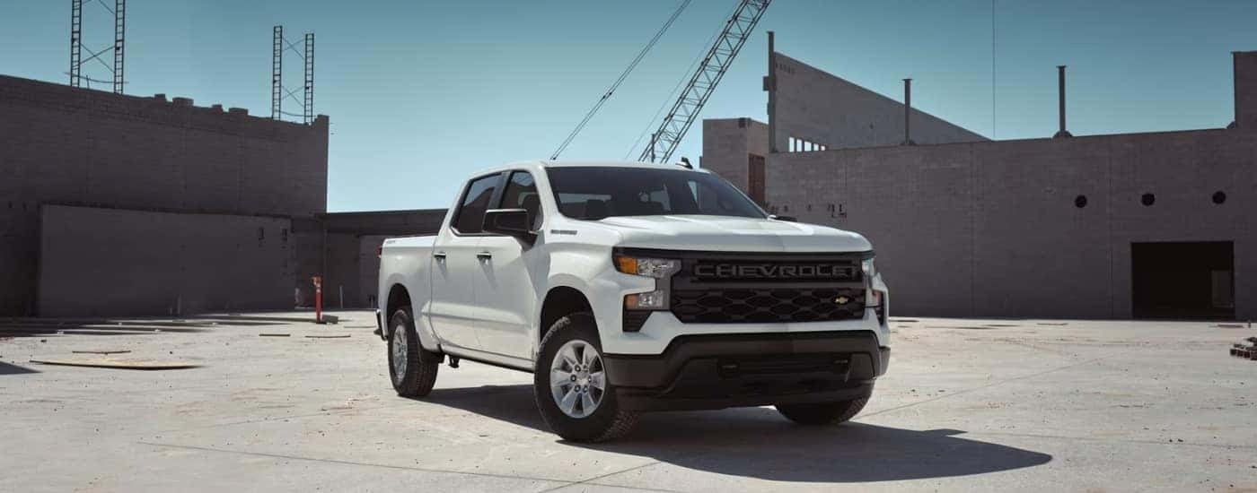 White 2024 Chevy Silverado 1500 WT parked near a Chevy Silverado 1500 dealer