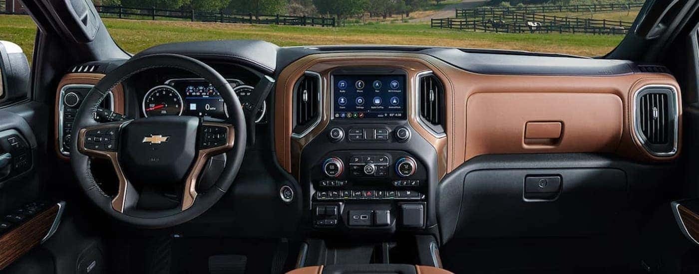 The black and brown interior shows the steering wheel and infotainment screen.