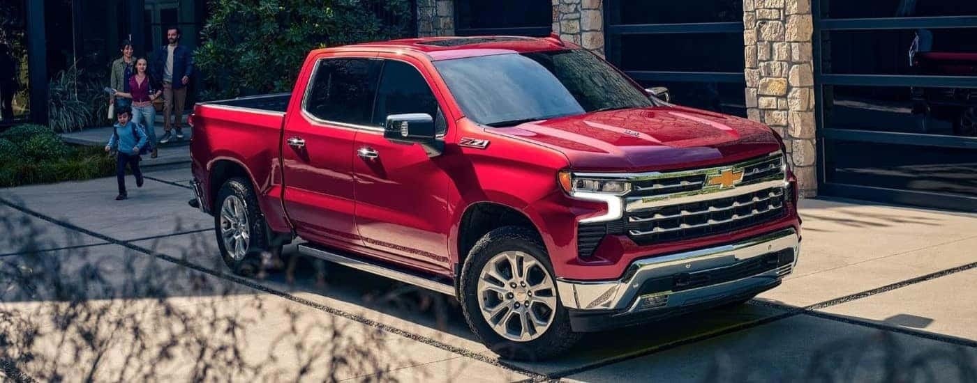 A red 2023 Chevy Silverado 1500 Z71 parked in a driveway.