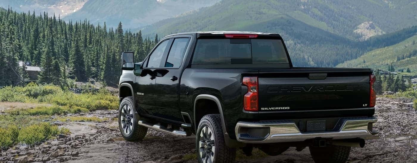 A black 2023 Chevy Silverado 2500 HD LT is shown overlooking a mountain view.