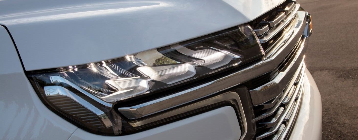 Close-up of the passenger side headlight on a white 2021 Chevy Suburban